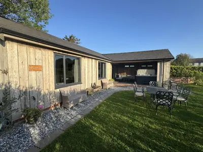 a backyard with a table and chairs in the grass at Wayside Lodge in Blackpool