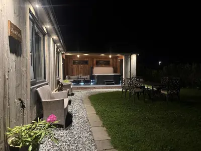a patio at night with a table and chairs at Wayside Lodge in Blackpool