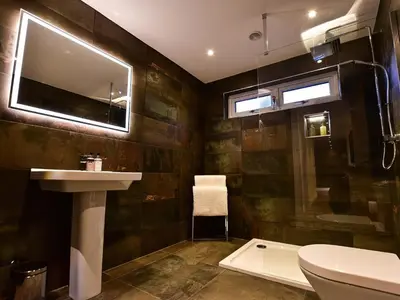 a bathroom with a sink and a toilet and a mirror at Wayside Lodge in Blackpool