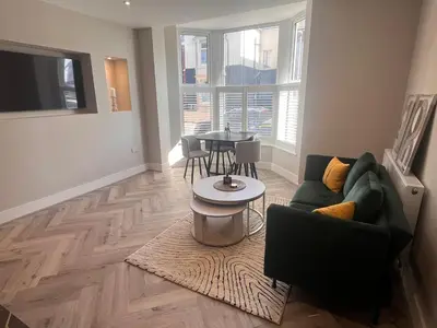 a living room with a couch and a table at Pleasure Beach Apartments by Central Beach Leisure in Blackpool