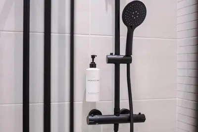 a bottle of soap on a holder in a shower at Pleasure Beach Apartments by Central Beach Leisure in Blackpool