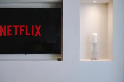a television with the netflix sign and a candle at Pleasure Beach Apartments by Central Beach Leisure in Blackpool