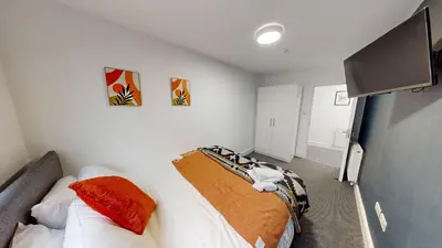 a bedroom with two beds and a flat screen tv at For Workers 10 Mins to City 5 TVs and Parking in Liverpool