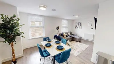 a living room with a table and chairs and a couch at For Workers 10 Mins to City 5 TVs and Parking in Liverpool