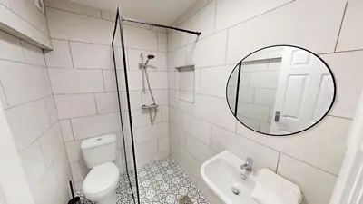 a bathroom with a toilet and a sink and a mirror at For Workers 10 Mins to City 5 TVs and Parking in Liverpool