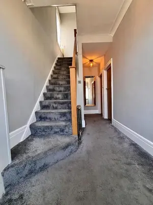 an empty hallway with stairs in a house at Crescent House, Pleasure Beach in Blackpool