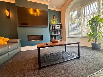 a living room with a couch and a coffee table at Crescent House, Pleasure Beach in Blackpool