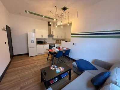a living room with a couch and a table at The Anfield Nook in Liverpool