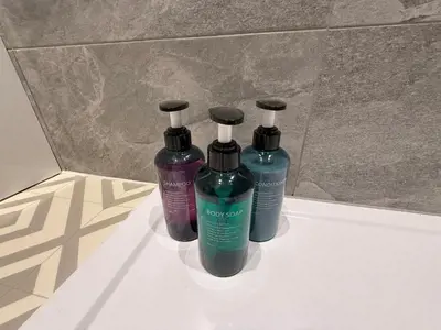 three bottles of shampoo and conditioner sitting on a counter at The Anfield Nook in Liverpool