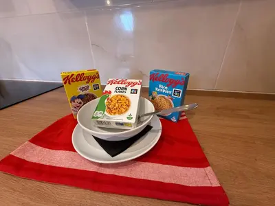 two boxes of cereal and a plate of food on a table at The Anfield Nook in Liverpool