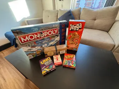 a table with a bunch of games on it at The Anfield Nook in Liverpool
