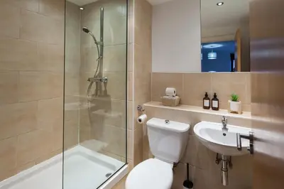 a bathroom with a shower and a toilet and a sink at Modern City Apartment By Chalefor Living in Liverpool