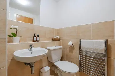 a bathroom with a toilet and a sink at Modern City Apartment By Chalefor Living in Liverpool