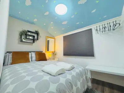 a bedroom with a bed with a blue ceiling at Room 2 Shared House in Bootle in Litherland