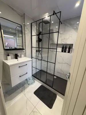 a bathroom with a glass shower and a sink at Anfield Home - Sleeps 7 - 1 min walk to Stadium! in Liverpool