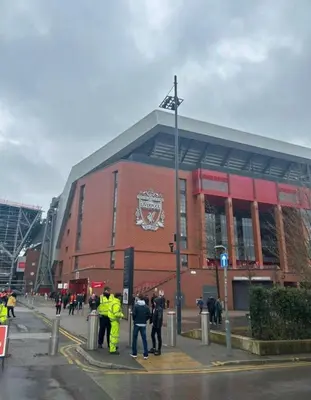 a group of people standing in front of a building at Anfield Home - Sleeps 7 - 1 min walk to Stadium! in Liverpool