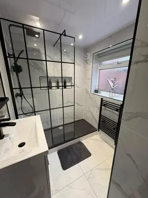 a bathroom with a shower and a sink at Anfield Home - Sleeps 7 - 1 min walk to Stadium! in Liverpool