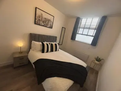 a bedroom with a bed and a window at 2 Bed Preston City Centre - Sleeps 4 with 1 Free Parking Space in Preston