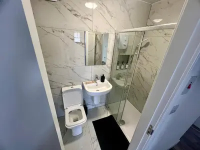 a bathroom with a sink and a toilet and a shower at 2 Bed Preston City Centre - Sleeps 4 with 1 Free Parking Space in Preston