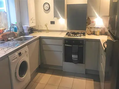 a kitchen with a stove and a washing machine at Contemporary House with a Woodland Setting in Skelmersdale