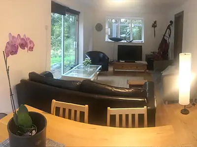 a living room with a couch and a table at Contemporary House with a Woodland Setting in Skelmersdale