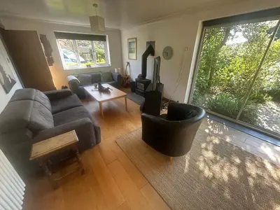 a living room with a couch and a table at Contemporary House with a Woodland Setting in Skelmersdale