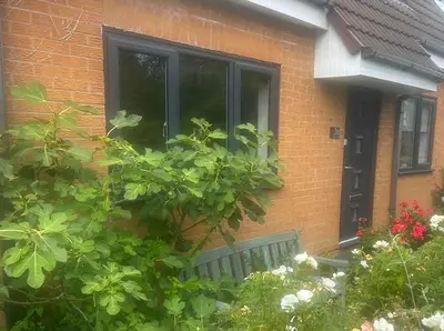 a brick house with a window and some plants at Contemporary House with a Woodland Setting in Skelmersdale