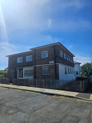 a brick building on the side of a street at Birkenhead House in Bidston
