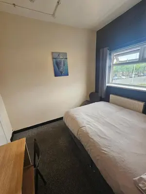 a bedroom with a bed and a window at Birkenhead House in Bidston