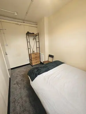 a bedroom with a white bed and a chalkboard at Birkenhead House in Bidston