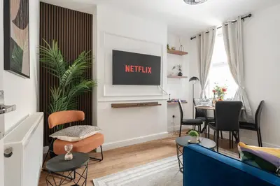 a living room with a couch and a table at Modern 4bedroom City Home Near LFC in Liverpool