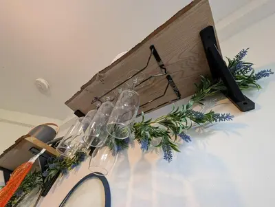 a table with wine glasses and a wooden box at Luxury 3 bed house with off road parking for 2 cars, garden, 10 minutes from city-centre in Liverpool