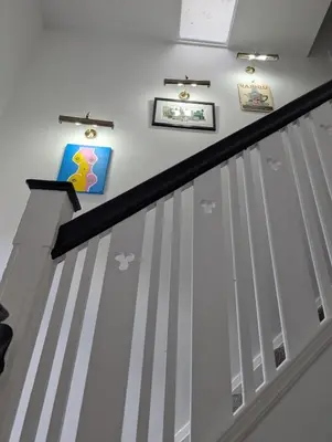 a staircase with white and gray stripes on the wall at Luxury 3 bed house with off road parking for 2 cars, garden, 10 minutes from city-centre in Liverpool