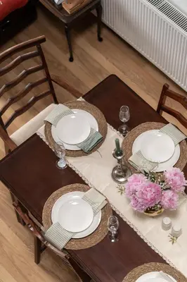 a table with two chairs and plates and flowers on it at The Liverpool Loft in city centre in Liverpool