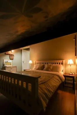a bedroom with a large bed and two lamps at The Liverpool Loft in city centre in Liverpool