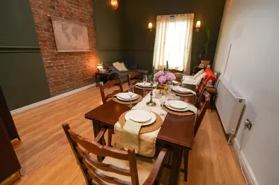 a dining room with a wooden table and chairs at The Liverpool Loft in city centre in Liverpool