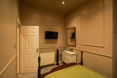 a bedroom with a bed and a tv on the wall at The Liverpool Loft in city centre in Liverpool