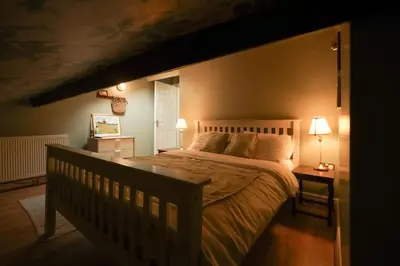 a bedroom with a large bed and two lamps at The Liverpool Loft in city centre in Liverpool