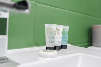 two tubes of sunscreen sitting on top of a bathroom sink at Elsie's Cottage in Ribchester