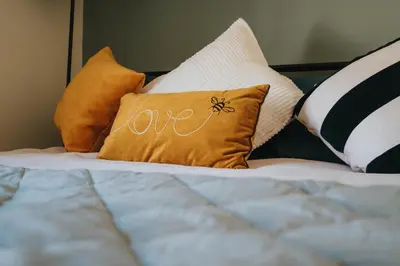 a pillow with the word love written on it on a bed at Elsie's Cottage in Ribchester