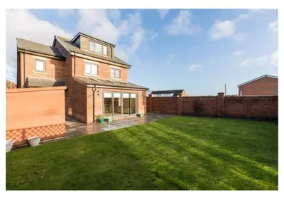 a large brick house with a large yard at Thirlmere in Upholland