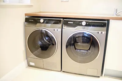two washing machines sitting next to each other in a laundry room at Thirlmere in Upholland