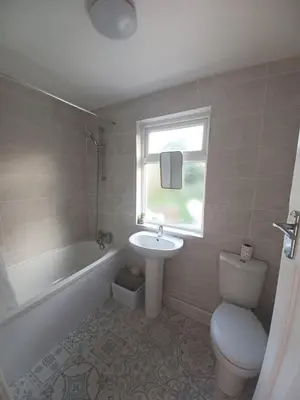a bathroom with a sink and a tub and a toilet at Heysham Seaside Hideaway in Heysham