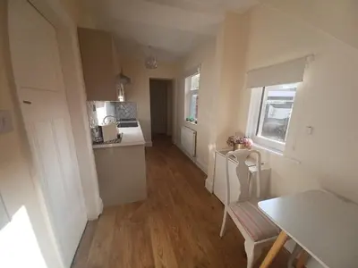 a room with a kitchen and a table and a dining room at Heysham Seaside Hideaway in Heysham