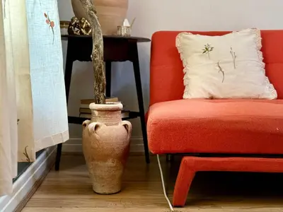 a living room with a chair and a plant in a vase at Aesthetic Architect designed Loft in City Centre in Liverpool