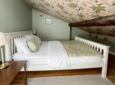 a bedroom with a white bed and a wooden table at Aesthetic Architect designed Loft in City Centre in Liverpool