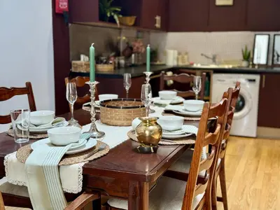 a dining room table with plates and glasses on it at Aesthetic Architect designed Loft in City Centre in Liverpool