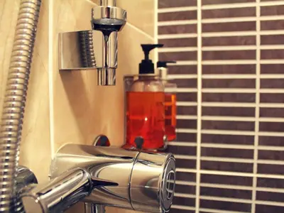 a bathroom sink with a soap dispenser next to a window at Ruskin Hotel in Blackpool