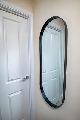 a mirror on a wall next to a door at Luxury 5BDR with City Access, Free Parking and Wi-Fi in Ince-in-Makerfield