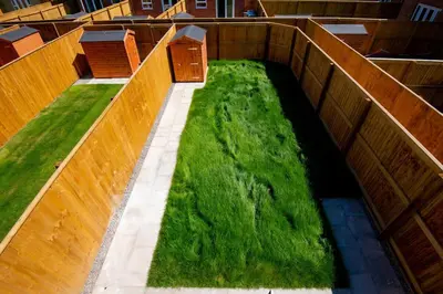 a garden with green grass on the side of a building at Luxury 5BDR with City Access, Free Parking and Wi-Fi in Ince-in-Makerfield